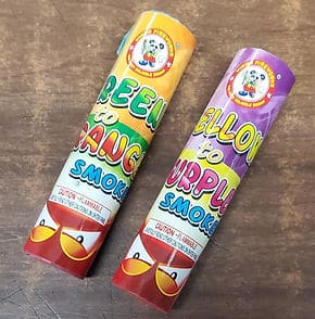 Colorful smoke tubes on wooden surface